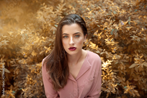 Young brunette woman portrait in nature
