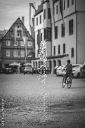Impressions of Nördlingen. Black and white moody photo of the romantic german town. Fountain in the old town.