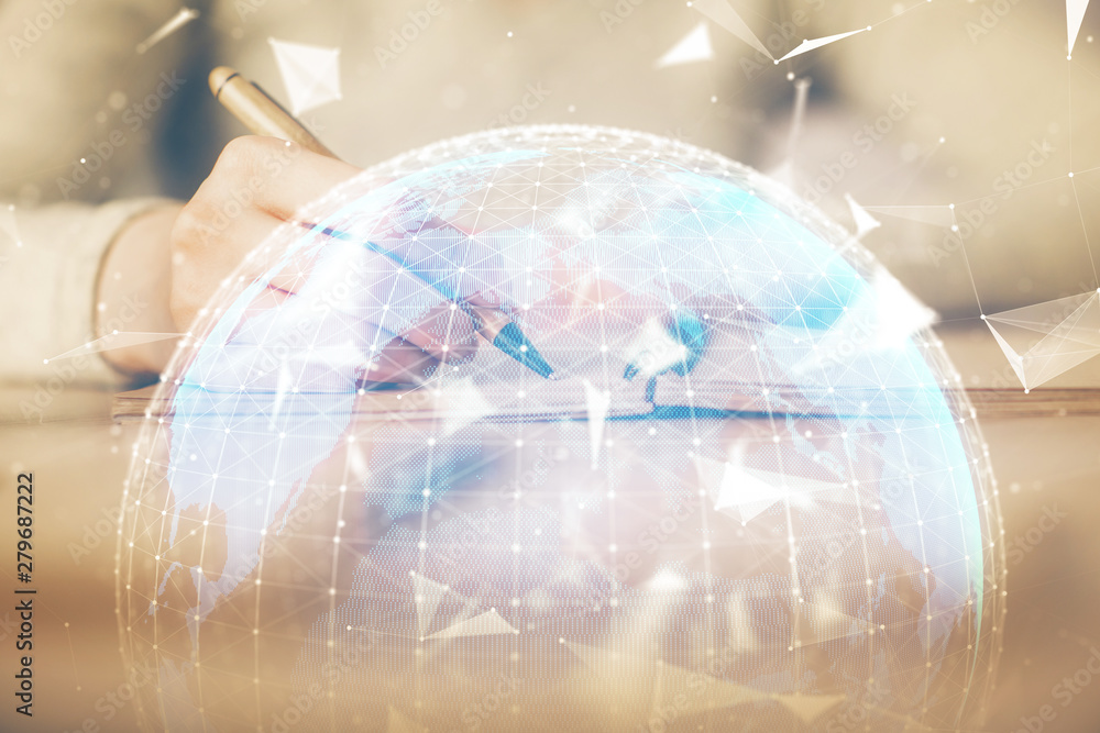 International business hologram over woman's hands taking notes background. Concept of success. Double exposure International business hologram over woman's hands taking notes background. Concept of success. Double exposure