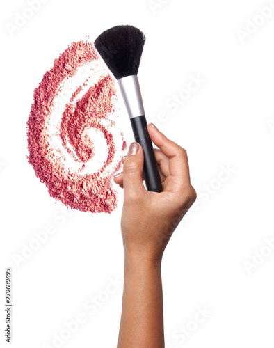 Women's hand with cosmetic accessories:powderbrush photo