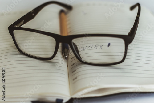 black glasses lie on the book on the table, rest in the process of education