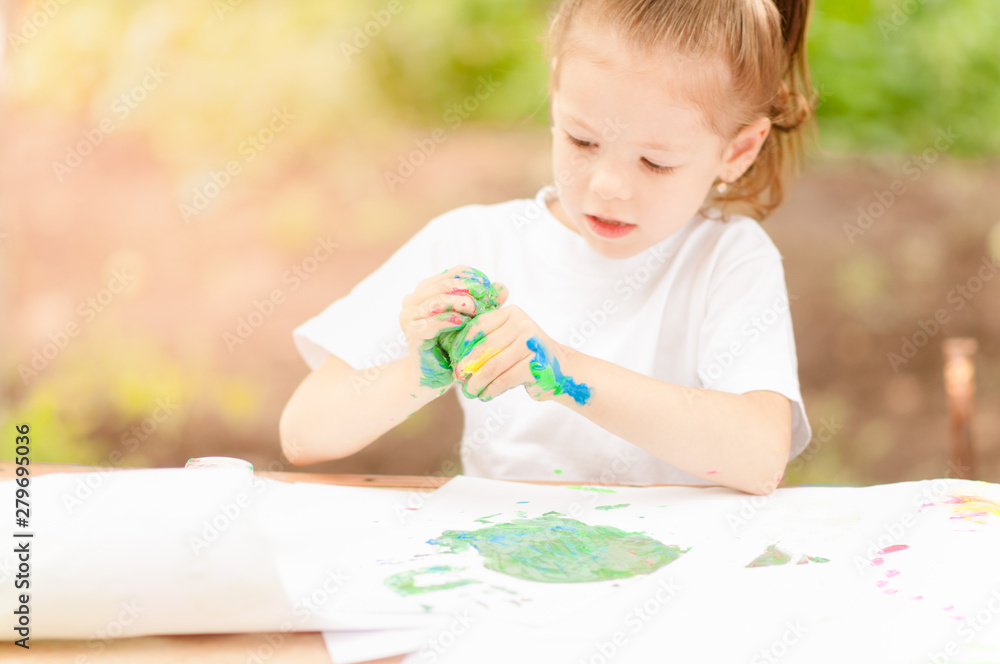 little girl is drawing with paints little girl is drawing with paints