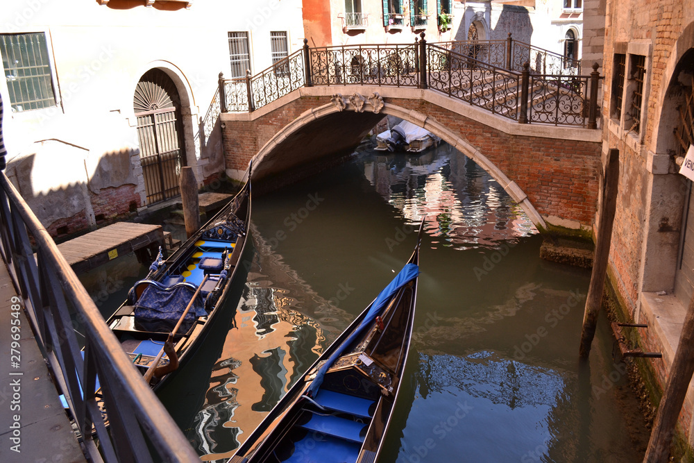 Traditional Venetian canal with bridge and gondolas.