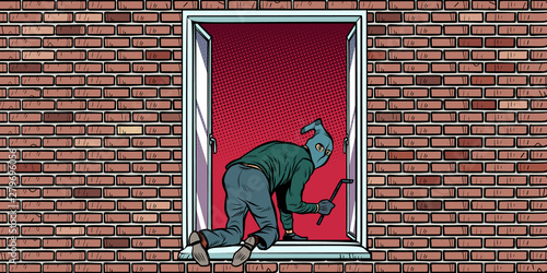 the thief is a burglar climbs in the window