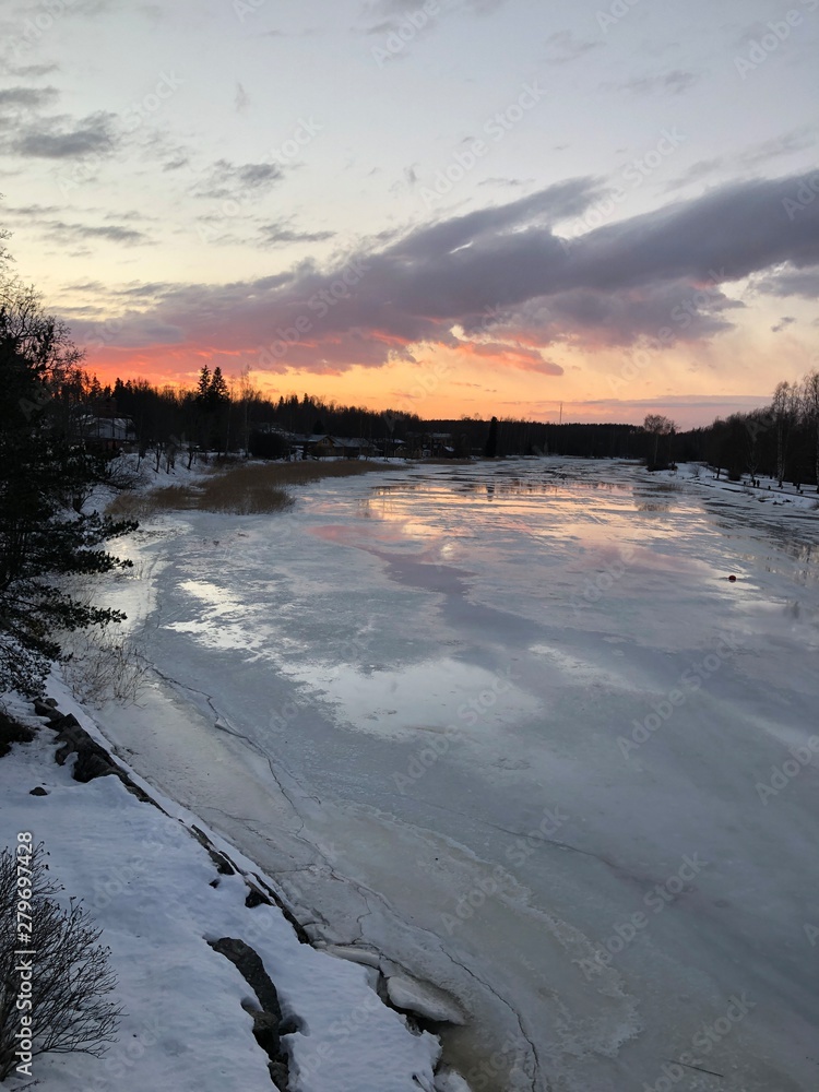 Fototapeta premium sunset over frozen lake