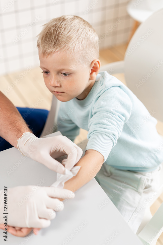 Sports injury. medical patch. Doctor makes bandage on hand patient, in the hospital Sports injury. medical patch. Doctor makes bandage on hand patient, in the hospital