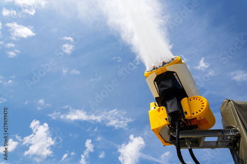 Snow making machines used to water grass on slope, sunny summer day, Wagrain ski resort, Austria photo