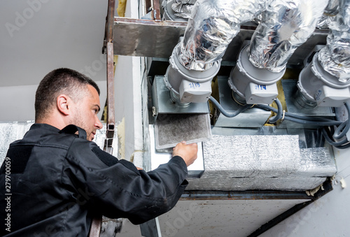 Ventilation cleaning. Specialist at work. Repair ventilation system (HVAC)