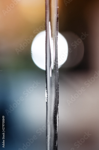 Frozen water jet on the background of light bokeh