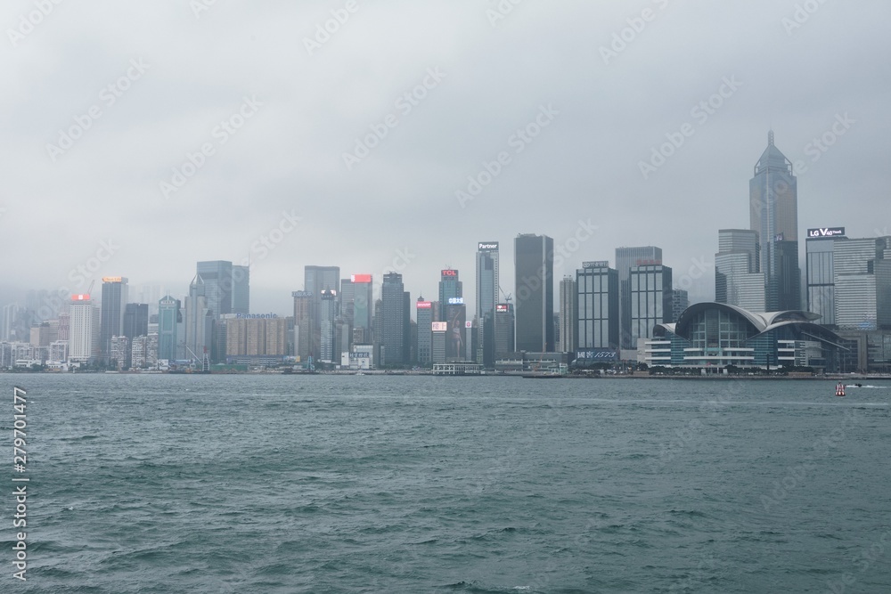 08 03 2019 China, Hong Kong, Victoria Harbour - skyscrapers in a cloudy day
