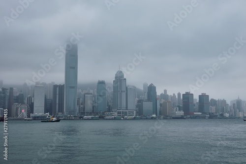 08 03 2019 China, Hong Kong, Victoria Harbour - skyscrapers and ships in a cloudy day