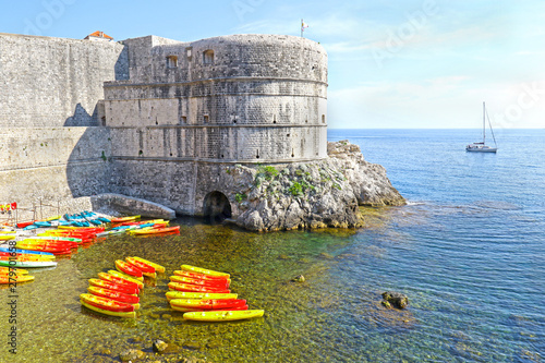 Kayaks at Kolorina beach, Old Town, City Wall in the background.  Dubrovnik, Croatia