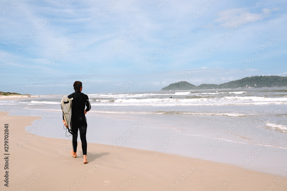 Beautiful scenic beach view at sunset with surfer siluette on the ocean beach, Florianopolis, Brasil, South America Beautiful scenic beach view at sunset with surfer siluette on the ocean beach, Florianopolis, Brasil, South America