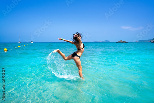 Ibiza beach girl splashing water in Balearics