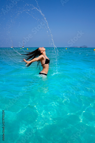 Ibiza beach girl water hair flip in Balearics