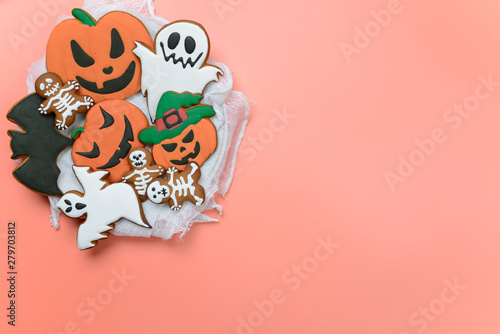 The hand-made eatable gingerbread Halloween pumpkin, ghosts, bat and sceletons on pink background photo