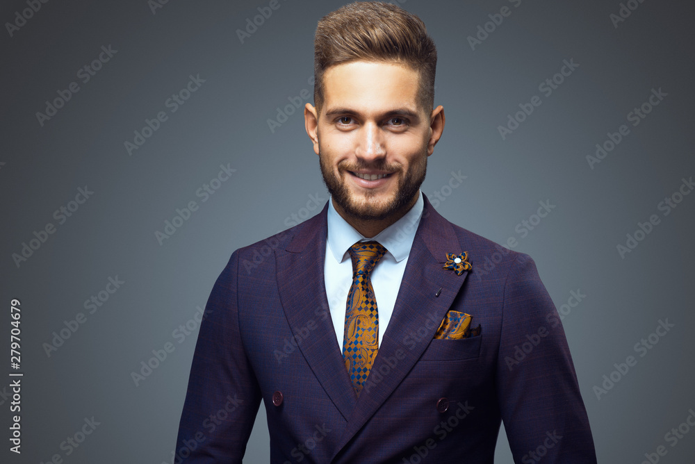 © Cressida studio - Stylish young man in suit and tie. Business style. Fashionable image. Office worker. Sexy man standing and looking at the camera