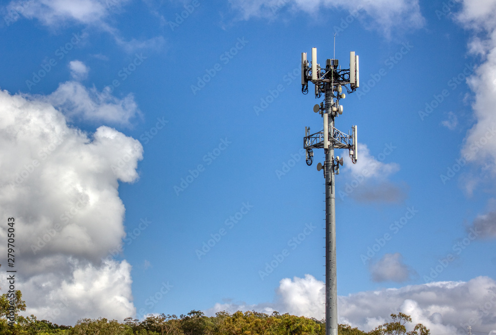 Cellular, mobile phone transmitter tower with blue sky and clouds 1 Cellular, mobile phone transmitter tower with blue sky and clouds 1