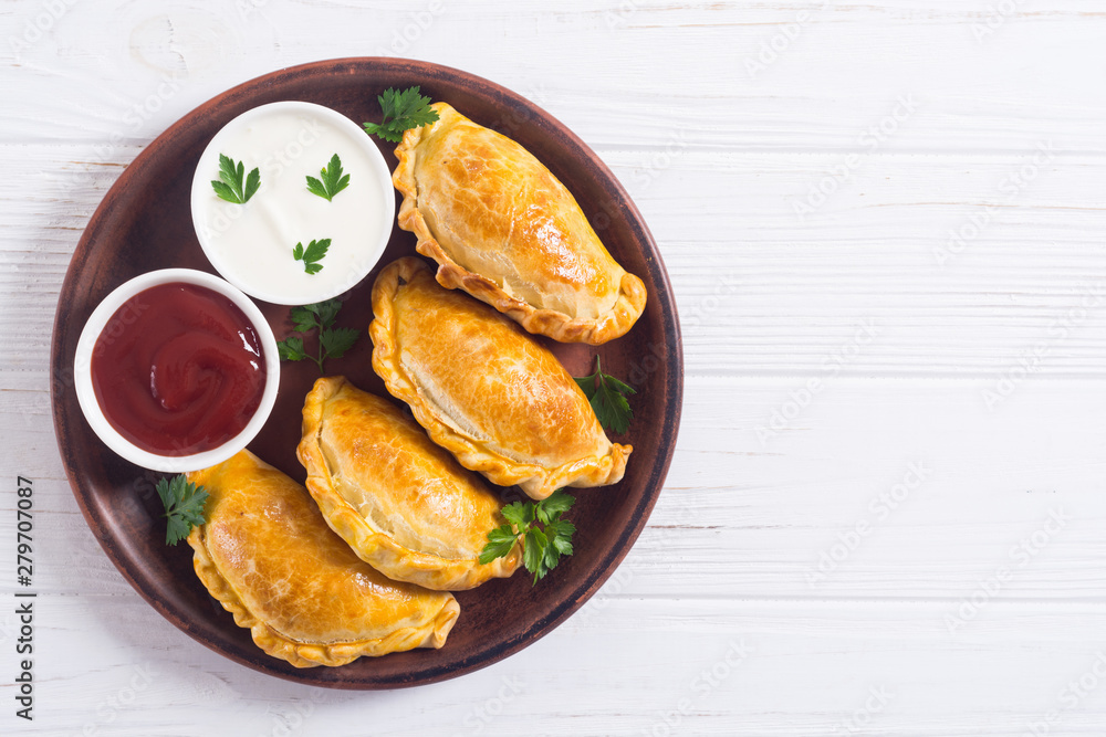 Latin American baked beef empanadas with sauce Latin American baked beef empanadas with sauce