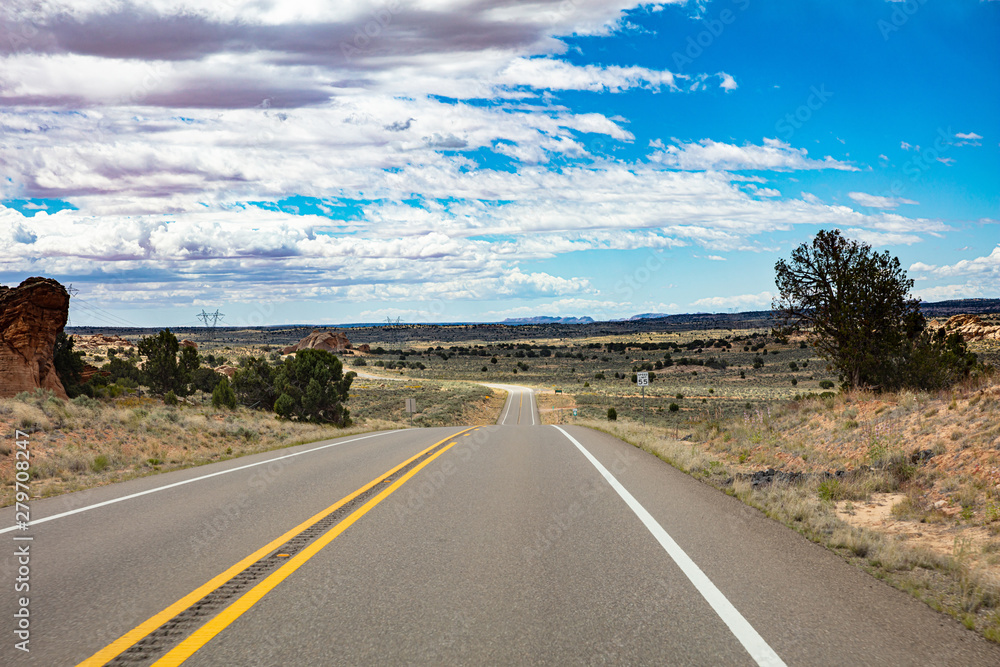 Fototapeta premium Long highway in the american countryside, blue sky