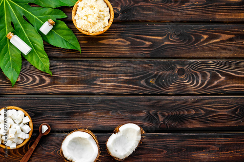 Homemade organic cosmetics with coconut on wooden background top view mock up