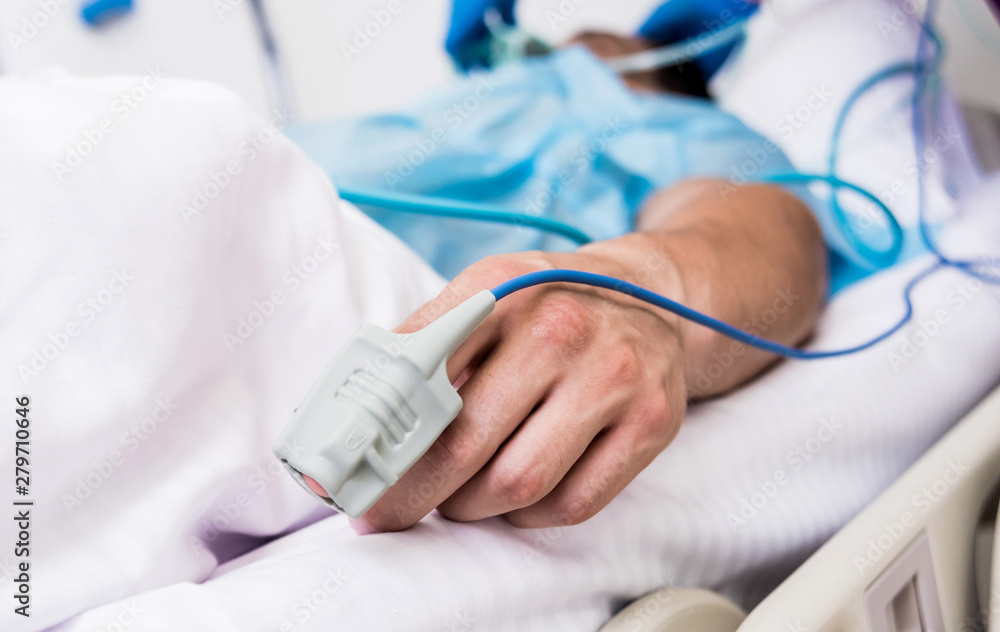 Fototapeta premium Doctors give resuscitation to a male patient in the emergency room. Cardiac massage