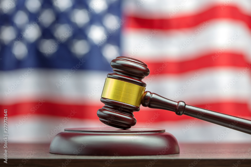 wooden gavel on usa flag backdrop