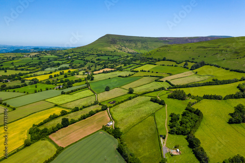 Tablou canvas Aerial view of green fields and farmlands in rural Wales
