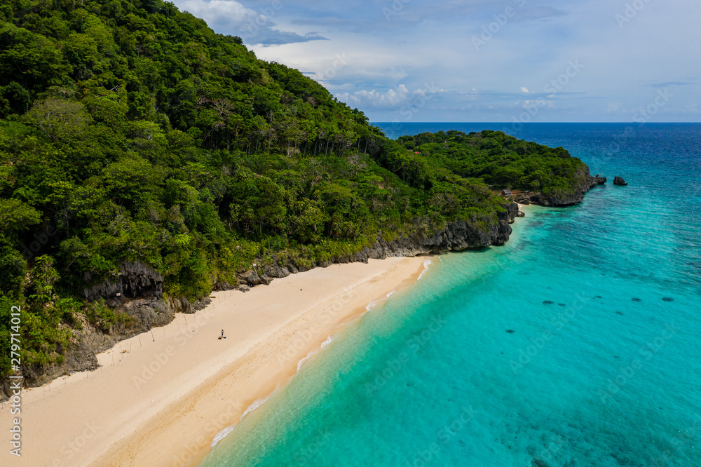 Aerial view of a beautiful sandy beach surrounded by tropical foliage (Pukka Shell Beach, Boracay, Philippines)
