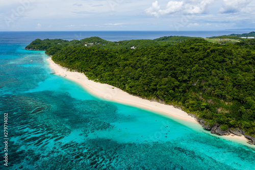Aerial view of a beautiful sandy beach surrounded by tropical foliage (Pukka Shell Beach, Boracay, Philippines) © whitcomberd