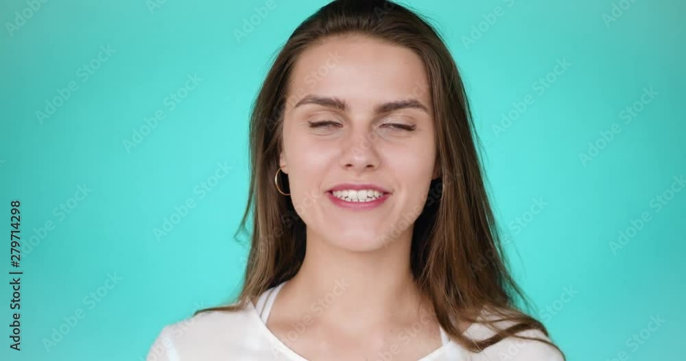 Girl smiles and covers her face with lemon. Girl made Lemon facial mask. Lemon face mask. Turquoise background. Girl smiles and covers her face with lemon. Girl made Lemon facial mask. Lemon face mask. Turquoise background.