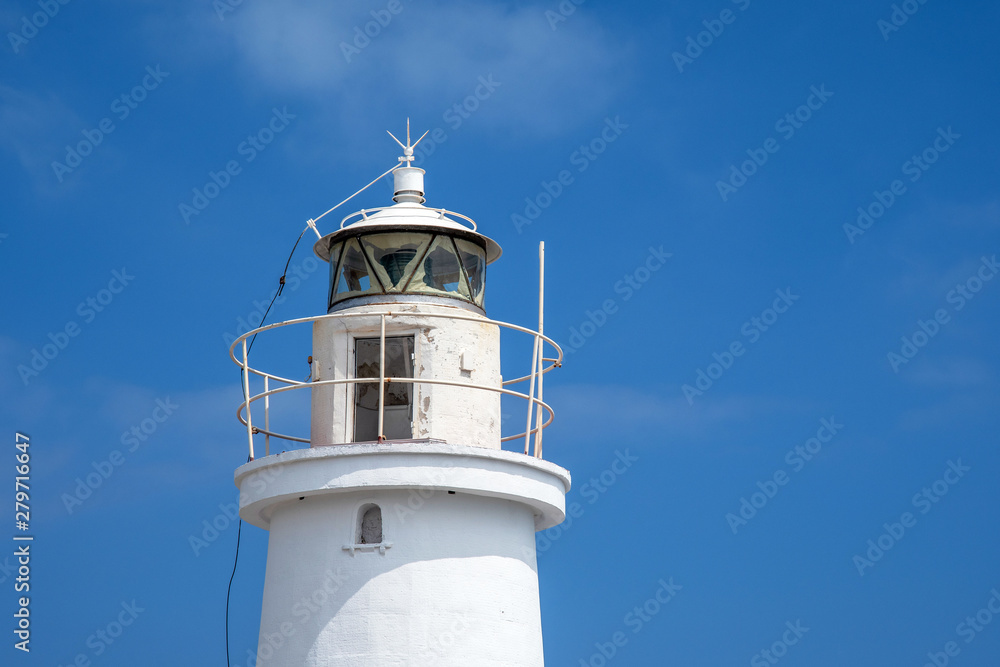 Top of a white lighthouse against a clear blue sky in a sunny summer day, Porto Maurizio, Imperia, Liguria, Italy