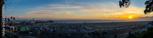 Panorama of Sunrise at Santa Monica Pier in California with ocean, beach, and amusement park