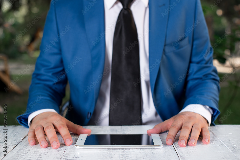 Businessman in blue suite with a tie holds lap top in hands. Businessman in blue suite with a tie holds lap top in hands.