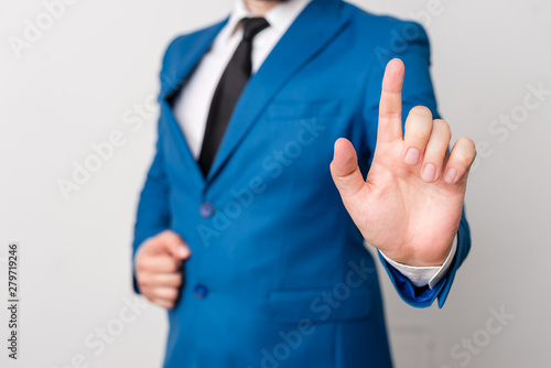 Businessman with pointing finger in front of him.