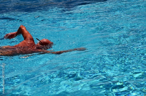 Man swimming freestyle laps in a condo swimming pool © Wimbledon
