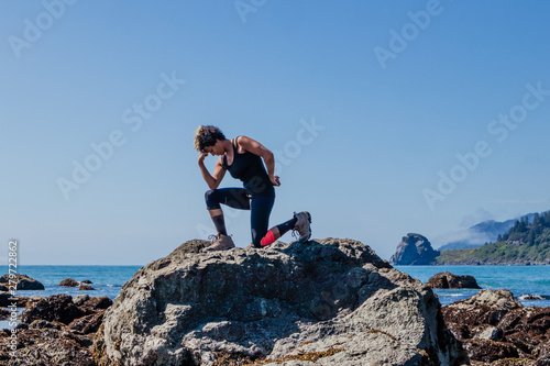 woman "thinker" on top of rock