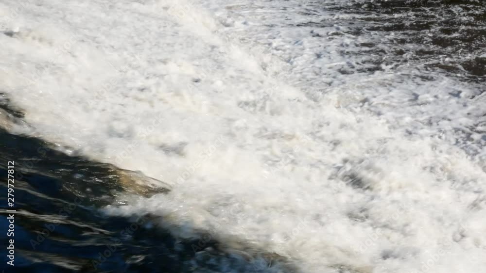 Fast flowing water over dam on Ave River in Portugal on a bright, sunny day in summer. Pan down. Fast flowing water over dam on Ave River in Portugal on a bright, sunny day in summer. Pan down.