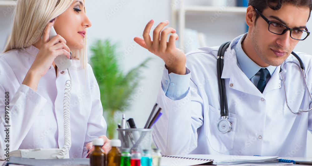 Male and female doctor having discussion in hospital Male and female doctor having discussion in hospital