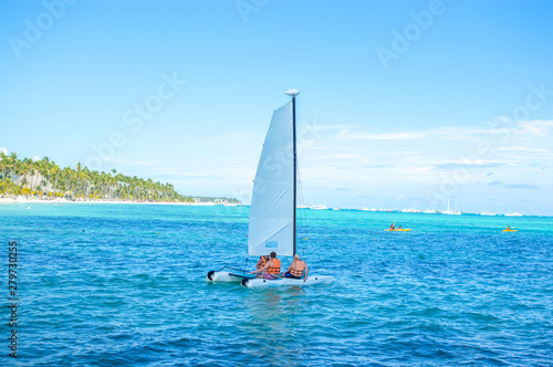 People swim on a yacht among palm trees in the resort of Punta Cana.