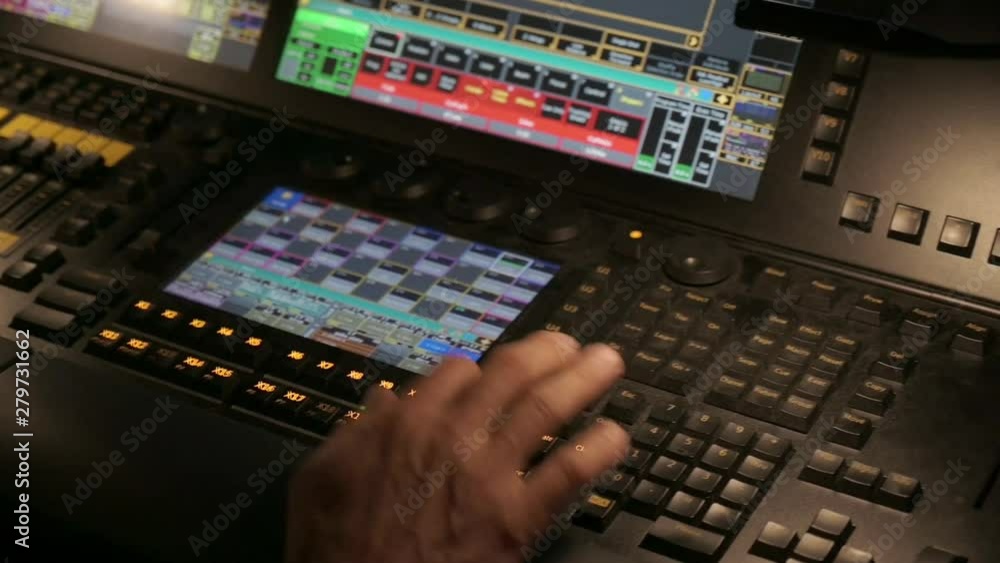 Hands using a control panel in a control room, during a live event. Close up. Hands using a control panel in a control room, during a live event. Close up.