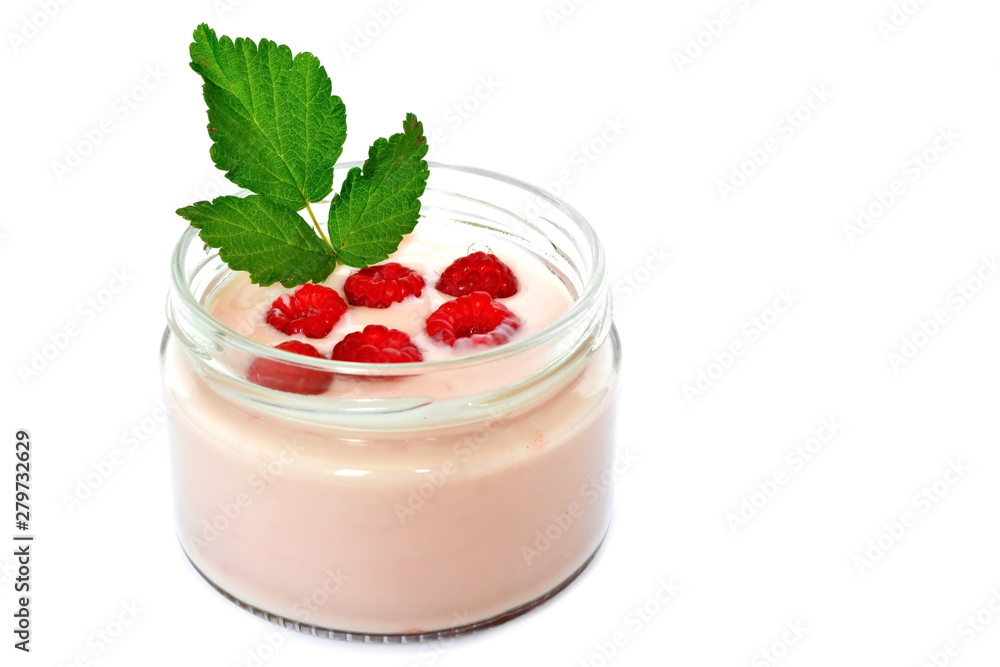 Pink cream or milk fruit yogurt natural with ripe red raspberry berry and green raspberry leaves in open glass transparent jar on a white background. Isolated Pink cream or milk fruit yogurt natural with ripe red raspberry berry and green raspberry leaves in open glass transparent jar on a white background. Isolated