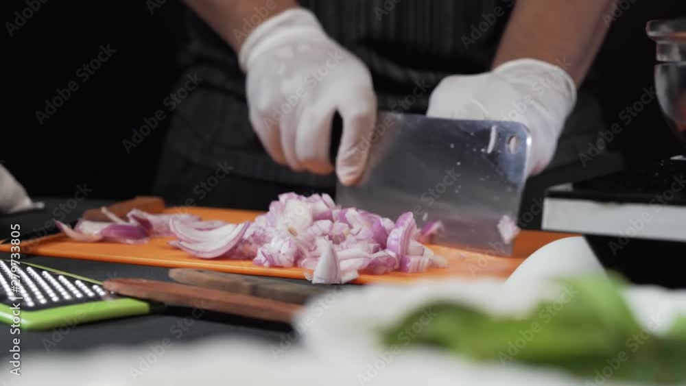 Cook with gloves is slicing onion. cinematic look Close Up Cook with gloves is slicing onion. cinematic look Close Up