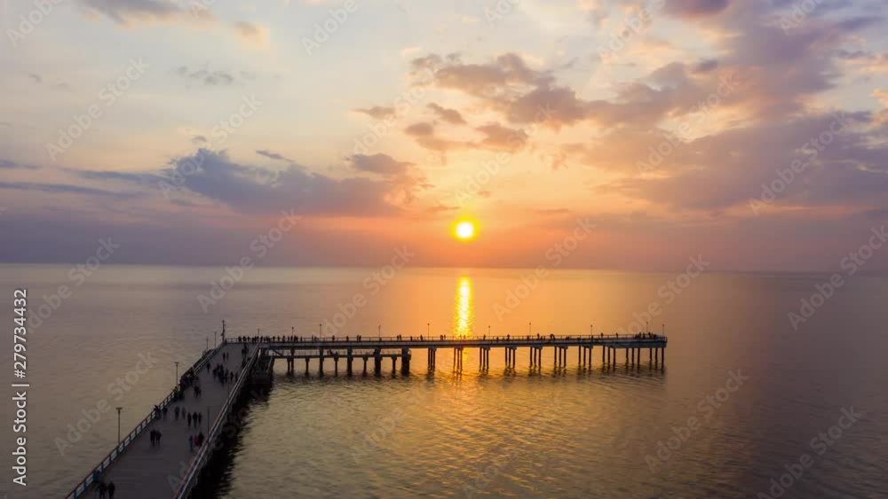 4k aerial hyperlapse timelapse of beautiful sunset in Palanga Lithuania with people walking across the bridge in the Baltic Sea, Europe 4k aerial hyperlapse timelapse of beautiful sunset in Palanga Lithuania with people walking across the bridge in the Baltic Sea, Europe