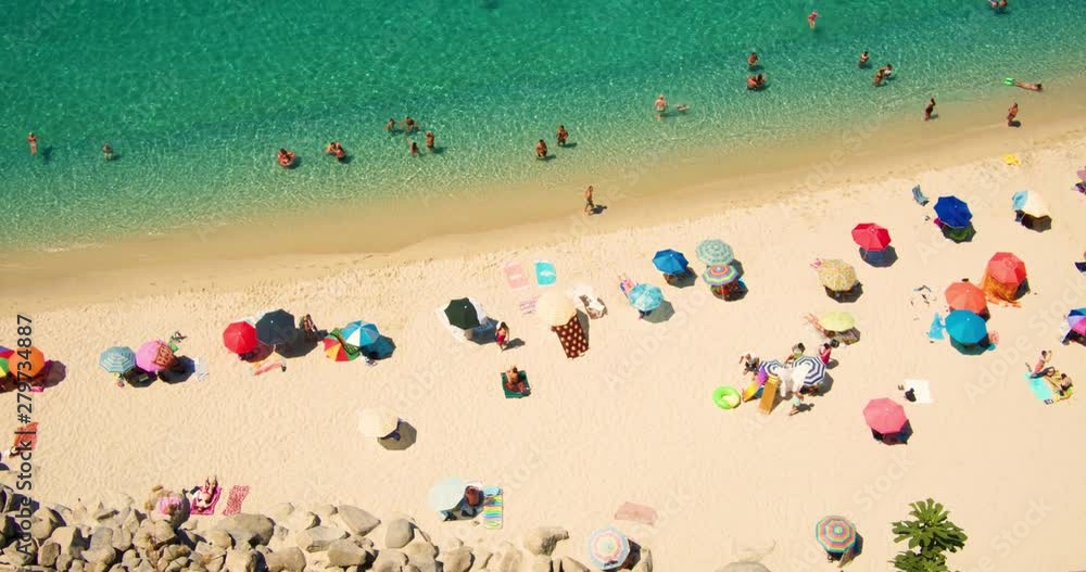 Wonderful sandy beach with bathers from above - people - ocean - vacation - slow motion Wonderful sandy beach with bathers from above - people - ocean - vacation - slow motion