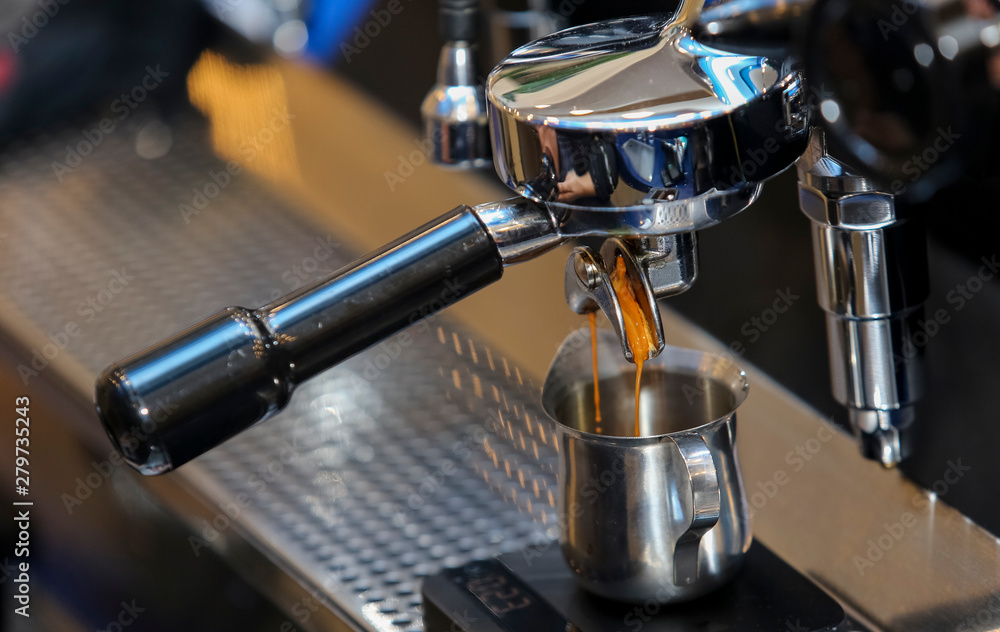 Espresso pouring from coffee machine