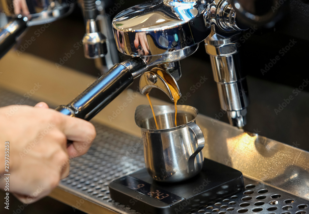 Espresso pouring from coffee machine Espresso pouring from coffee machine