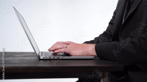 Caucasian Businessman With Fancy Suit Working at A Desk in a Plain White Room