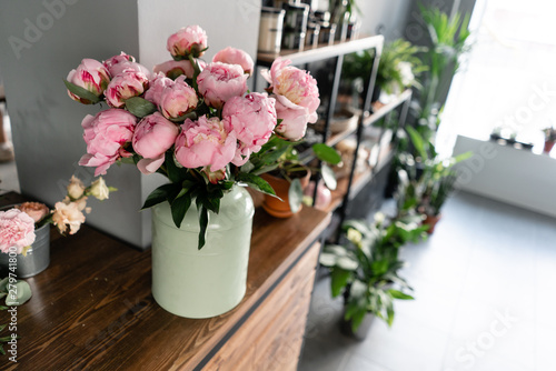 The counter of the flower shop. Pink peonies in a metal vase. Beautiful peony flower for catalog or online store. Floral shop concept . Beautiful fresh cut bouquet. Flowers delivery © malkovkosta