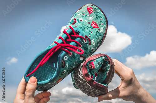 Fototapeta Woman is holding barefoot shoes with flexible sole